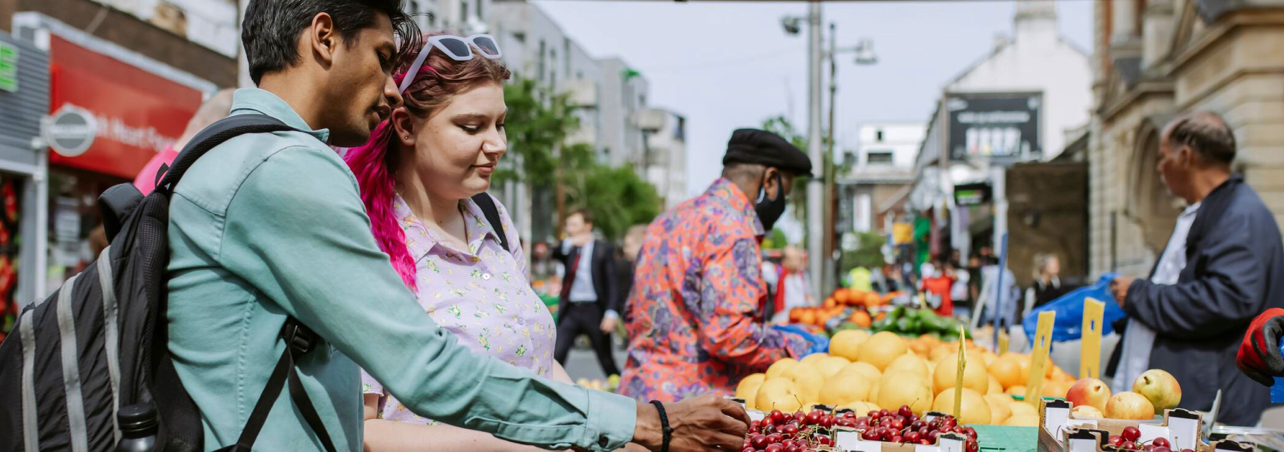 Students buying fruit in the market